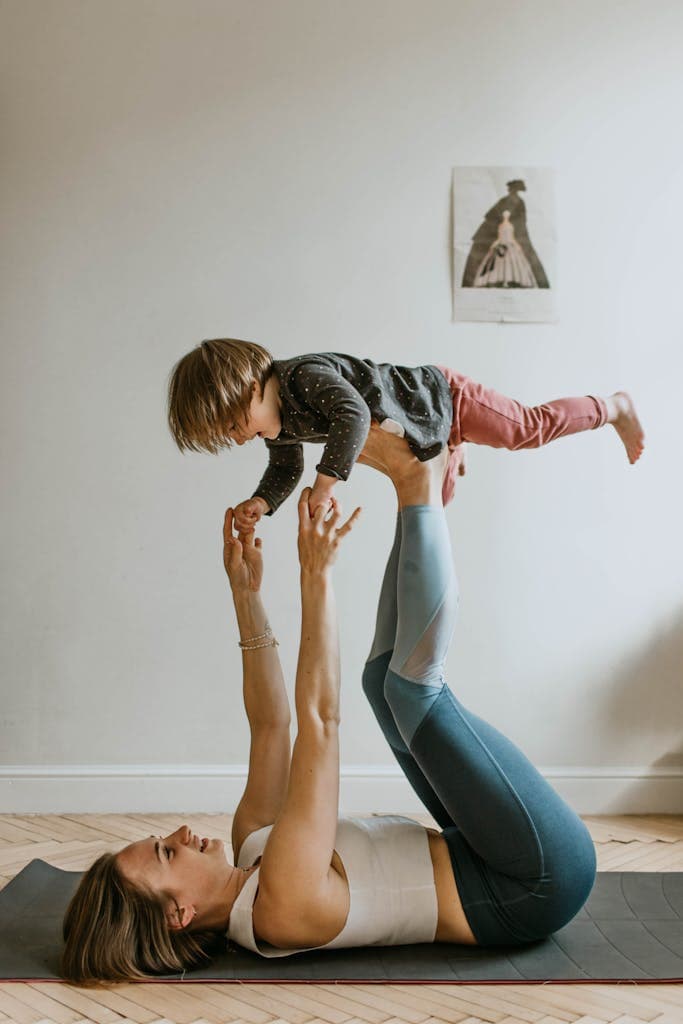 A mother and daughter bonding through acro yoga at home, showcasing strength, balance, and togetherness.